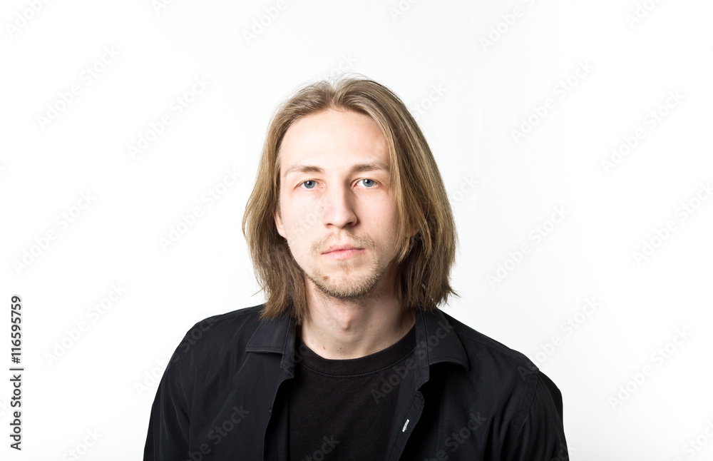 Portrait of young man with long blond hair, black shirt, white b Portrait of young man with long blond hair, black shirt, white b