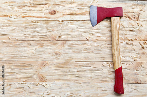 axe on a wooden background photo