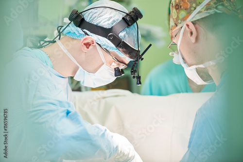 male cardiac surgeon at child cardiosurgery operating room photo