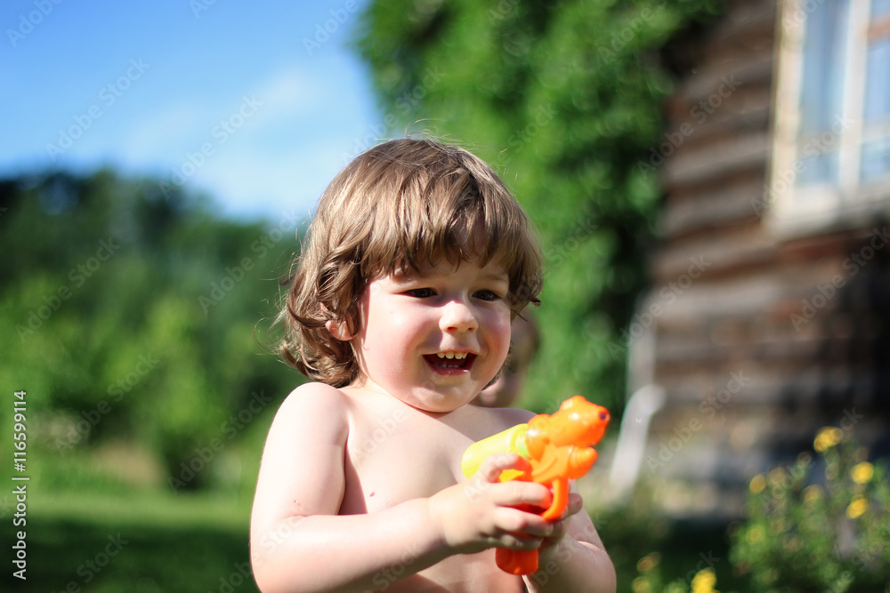 children playing with a water pistol children playing with a water pistol