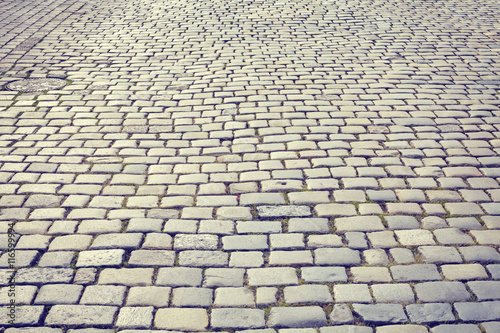 Vintage toned cobblestone street in Poznan, Poland