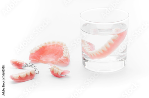 Set of Denture in glass of water on white background