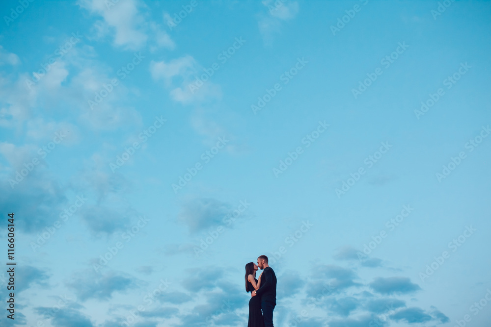 Love story . Couple at sunset. On the background of the sky. Clouds. Love story . Couple at sunset. On the background of the sky. Clouds.