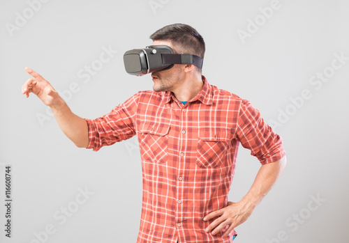 Man with virtual reality glasses showing gesture