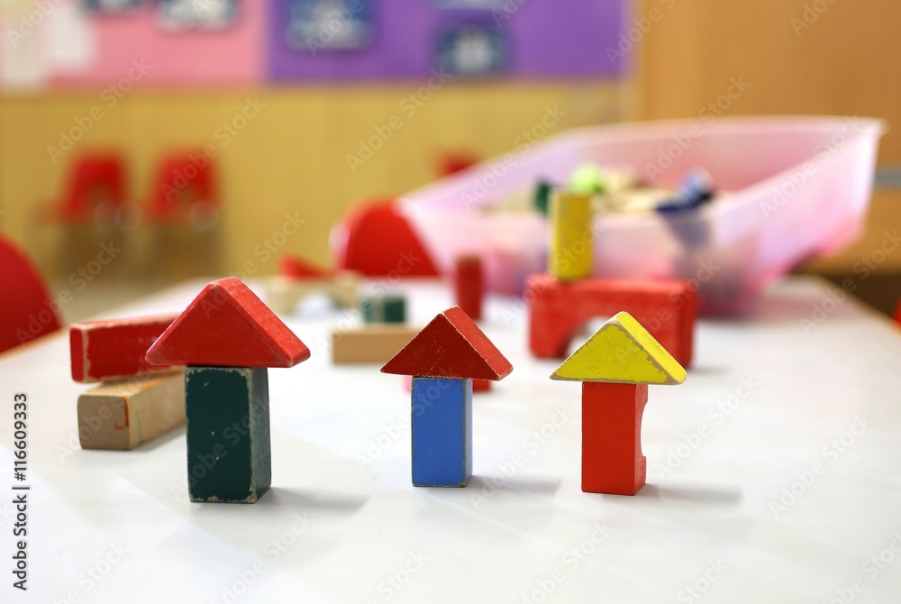 wooden toys and pieces of buildings in the nursery class
