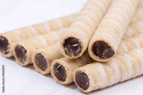 Chocolate wafer cream rolls isolated over white background
