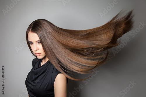 Beautiful model with smooth flying hair photo