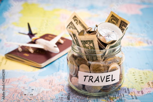 Travel budget concept with compass, passport and aircraft toy