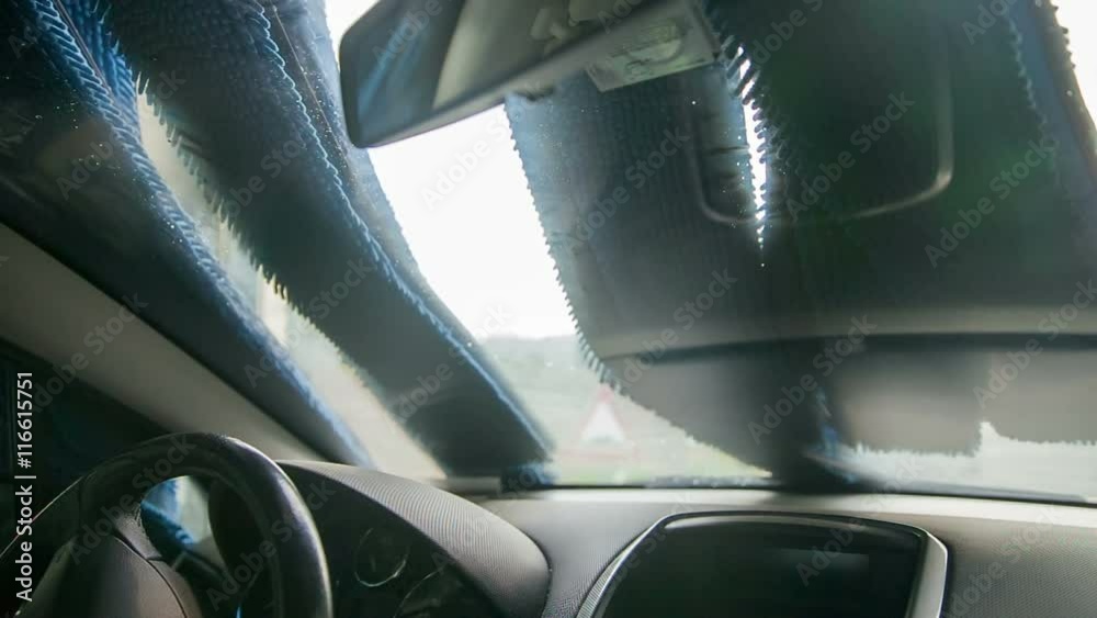 A car is coming out of a car wash. The soft brushes are moving away and the vehicle is now clean and ready to go. Close-up shot.
A car is coming out of a car wash. The soft brushes are moving away and the vehicle is now clean and ready to go. Close-up shot.