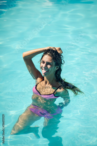 sexy young woman in swimming pool water