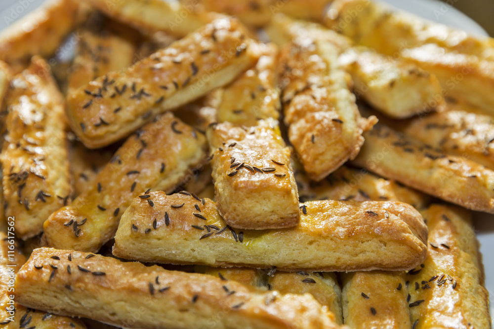 baked puff cheese sticks with caraway seeds closeup