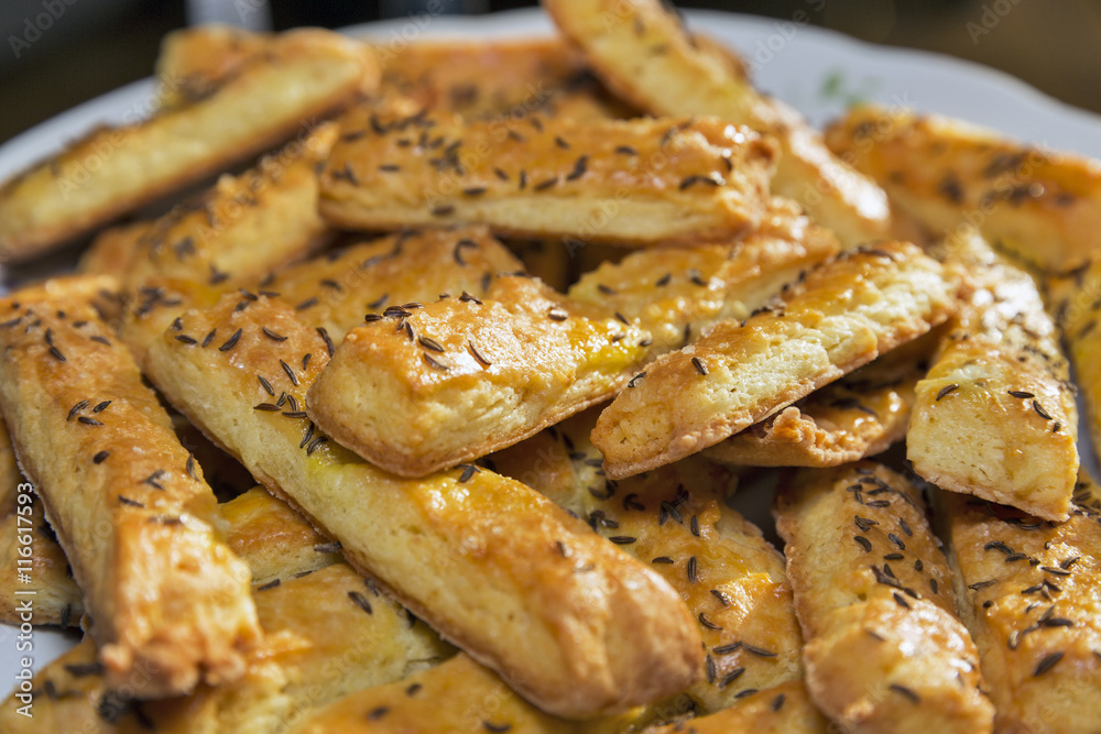 baked puff cheese sticks with caraway seeds closeup