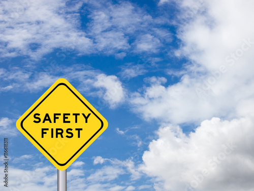 wording "Safety first" on yellow traffic sign on the blue sky