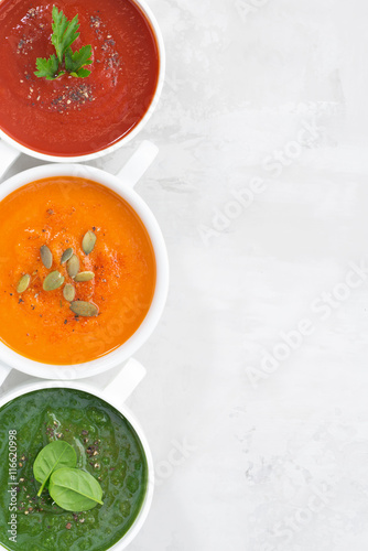 assortment of colorful vegetable cream soup on 