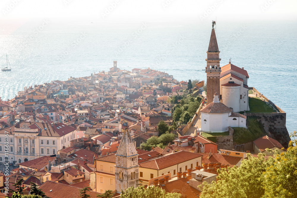 Aerial city scape view on Piran town with church tower and Adriatic sea on the background in Slovenia