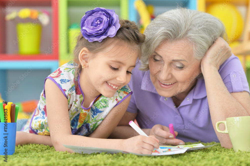 Grandmother with granddaughter drawing together Grandmother with granddaughter drawing together