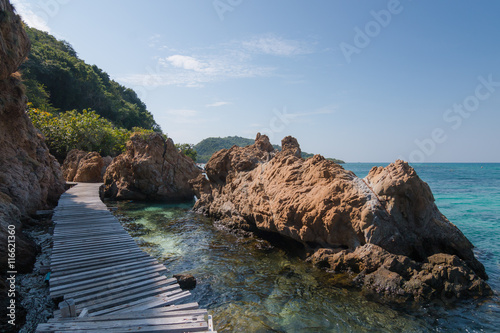 wood bridge for sightseeing sea beside by rock