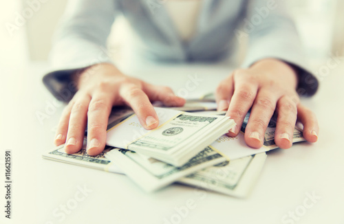close up of woman hands counting us dollar money