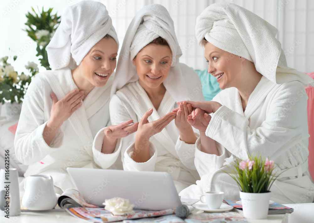 women wearing a white bathrobes with laptop women wearing a white bathrobes with laptop