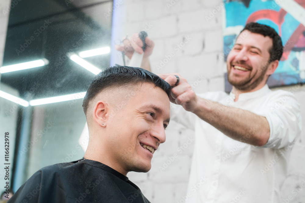 Male Barber Giving Client Haircut In Shop Male Barber Giving Client Haircut In Shop