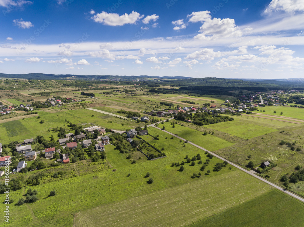 Rural landscape with green hill and blue sky in Poland. View fro