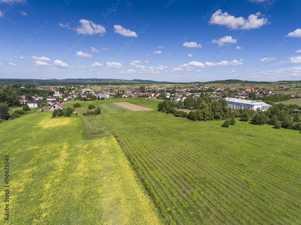 Naklejka premium Rural landscape with green hill and blue sky in Poland. View fro