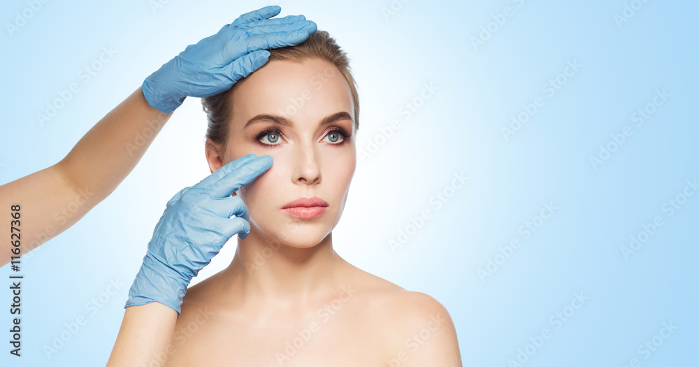 surgeon or beautician hands touching woman face