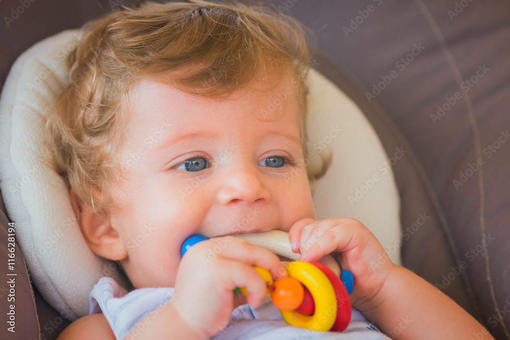 Baby boy playing with colorful toy,close-up. Baby boy playing with colorful toy,close-up.