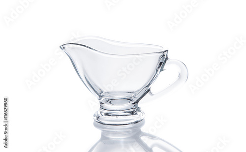 Glass sauceboat on white background photo