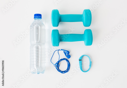 dumbbells, fitness tracker, earphones and bottle