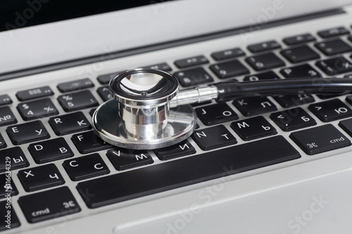 Medical stethoscope on a laptop computer, close up
