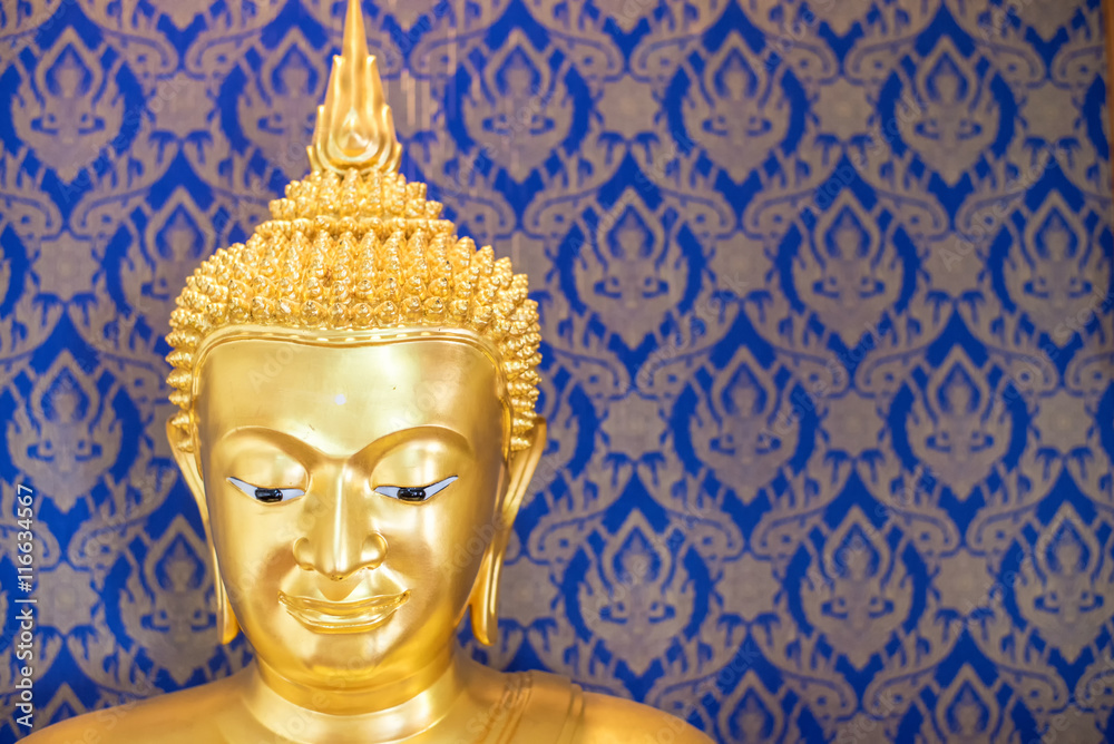 Buddha gold statue on blue background patterns Thailand.