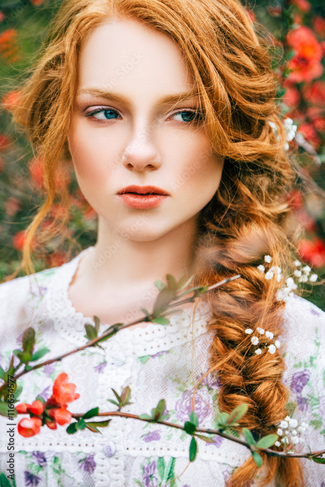 Portrait of a beautiful redhead girl in the spring garden Portrait of a beautiful redhead girl in the spring garden