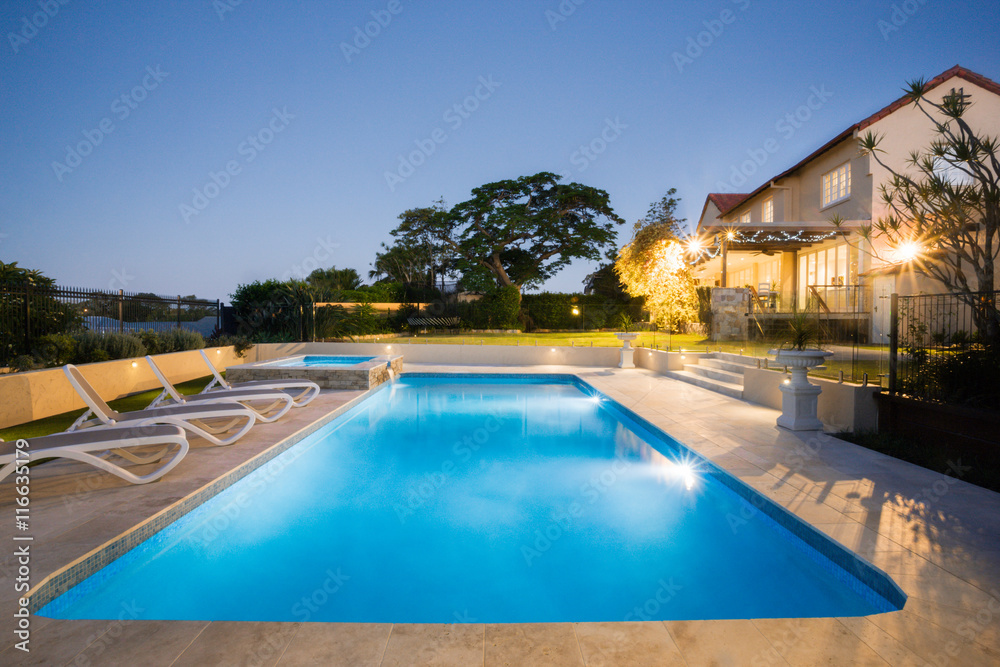 Luxury swimming pool at night with flashing lights