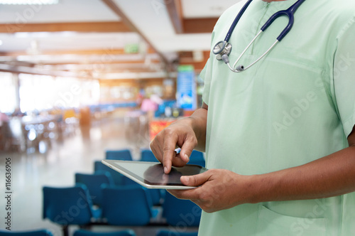 nurse working with tablet in hospital photo