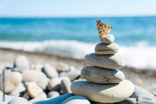 Photography Smooth stones stacked on each other on the beach