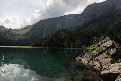 Reflections of the mountains in Obernberger See Tyrol Austria photo