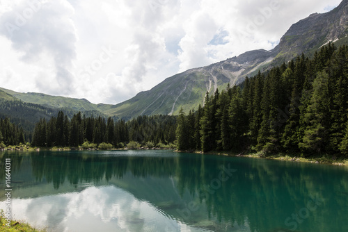 Reflections of the mountains in Obernberger See Tyrol Austria