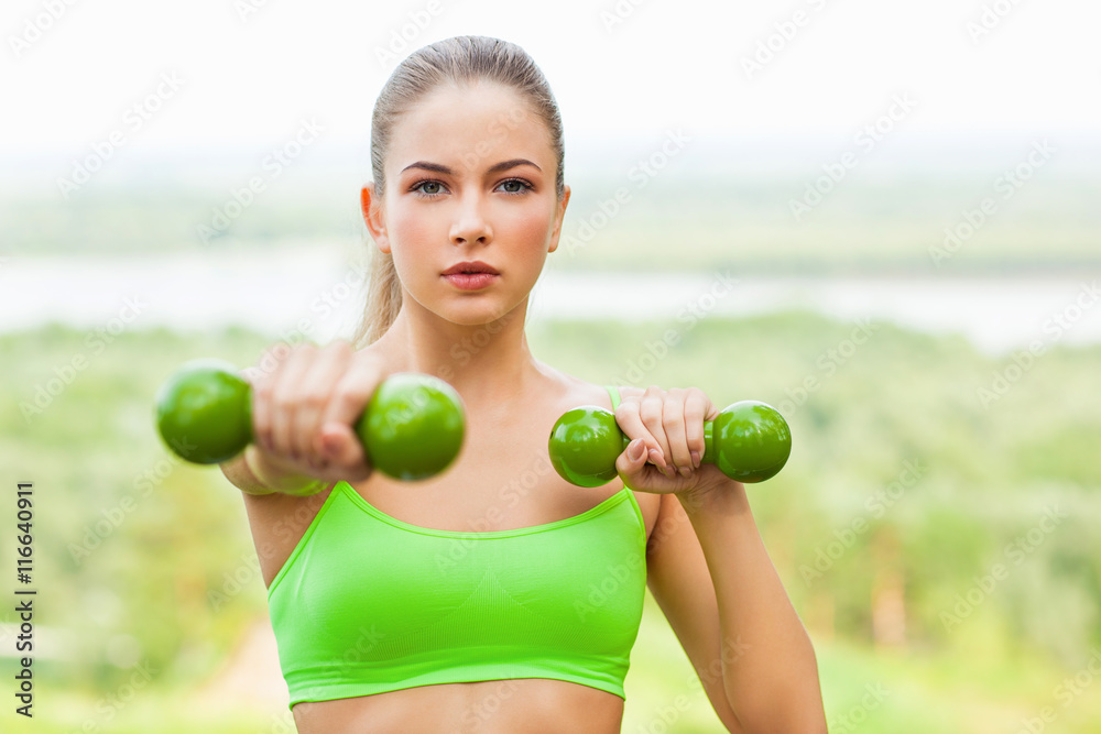 Young sporting woman with dumbells Young sporting woman with dumbells
