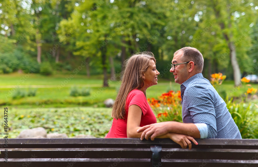 pregnant woman with her husband in park pregnant woman with her husband in park
