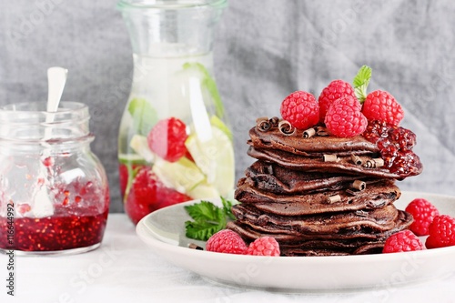 Chocolate pancakes with fresh raspberries. Selective focus