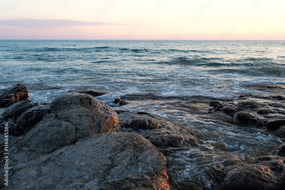 Sunset on the rocky seashore