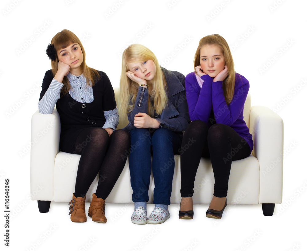 Obraz premium Young girls are sad sitting on couch