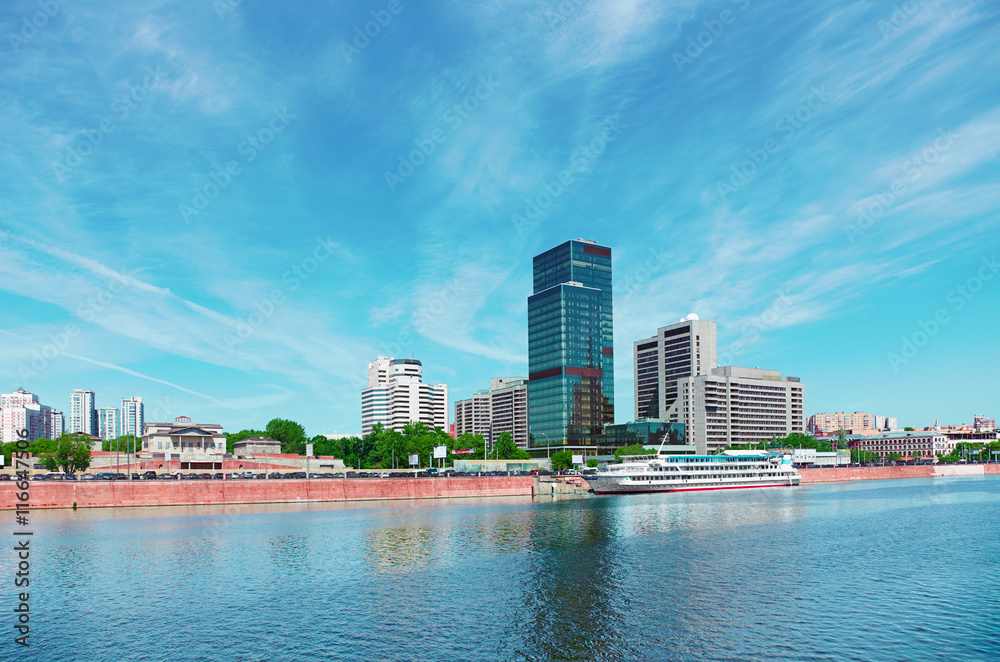 Fototapeta premium High-rise building on riverbank. Urban landscape