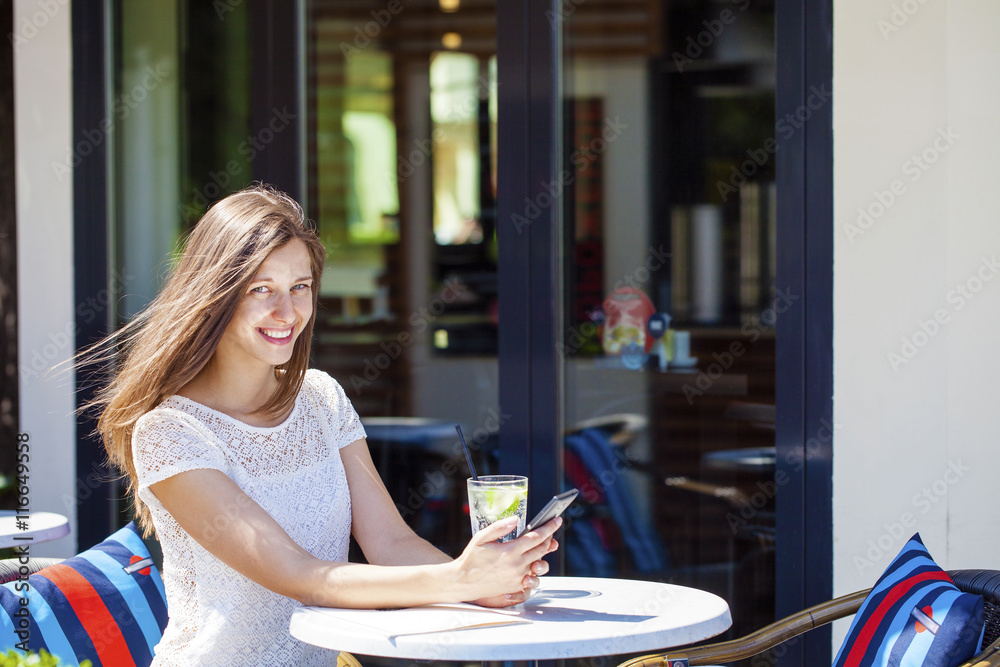 A woman relaxing with a drink A woman relaxing with a drink