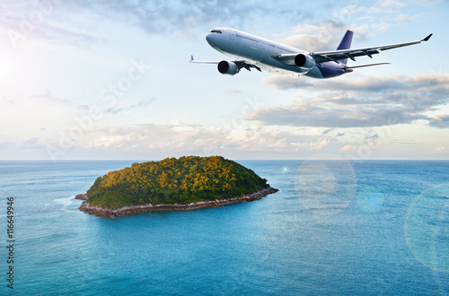 Passenger plane over tropical island