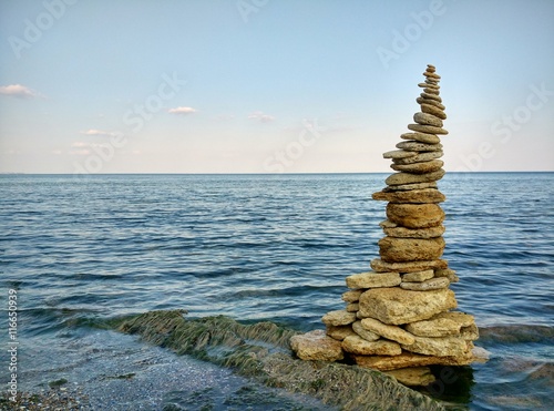 Balancing stones on the beach