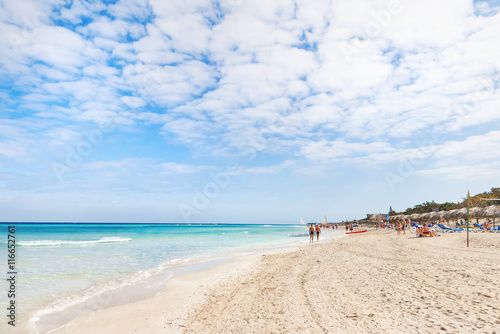 Tourists relax on Varadero sandy beach. Cuba.
