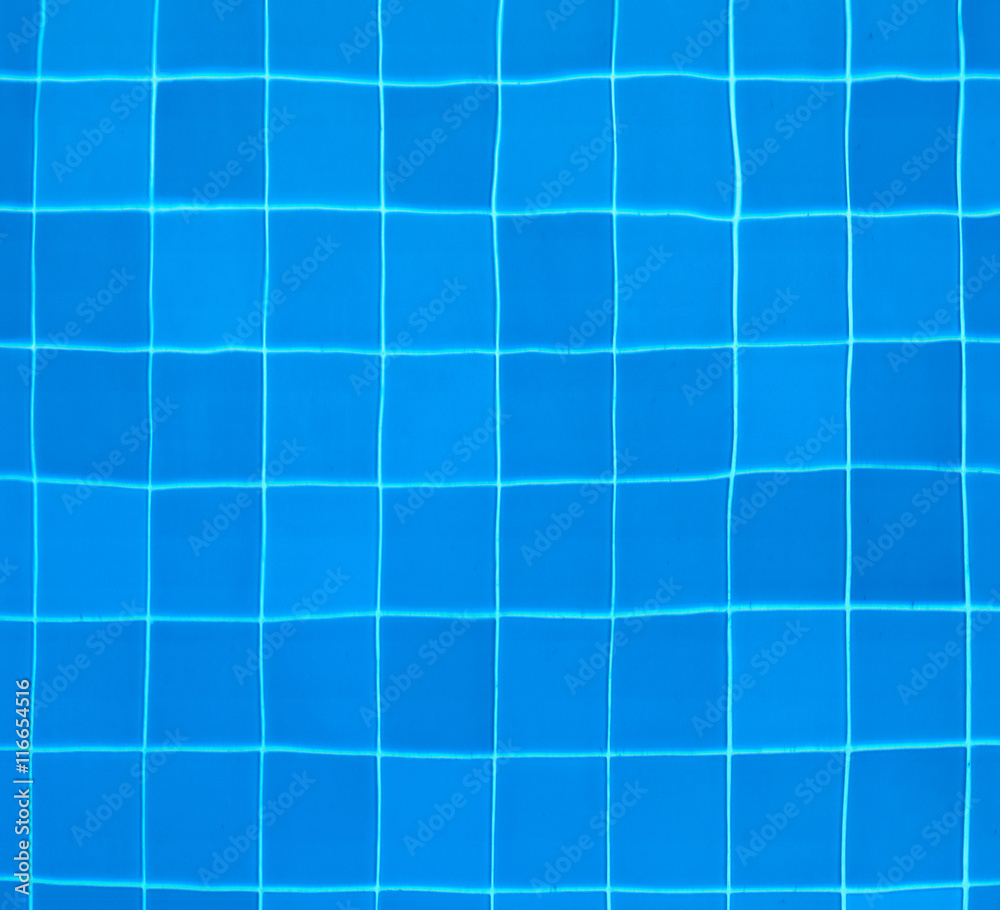 Tiles at the bottom of a swimming pool Tiles at the bottom of a swimming pool