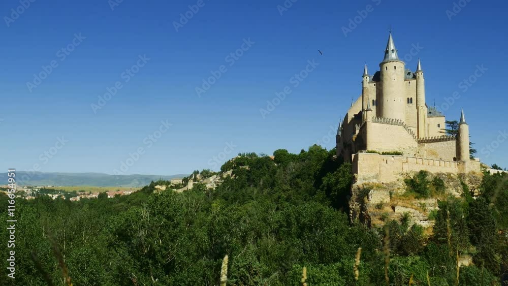 Middle age castle, romantic medieval fortress with perfect evening colored sunset light and beautiful clouds. The spanish castle Alcazar of Segovia, in Castilla y Leon, Spain Middle age castle, romantic medieval fortress with perfect evening colored sunset light and beautiful clouds. The spanish castle Alcazar of Segovia, in Castilla y Leon, Spain